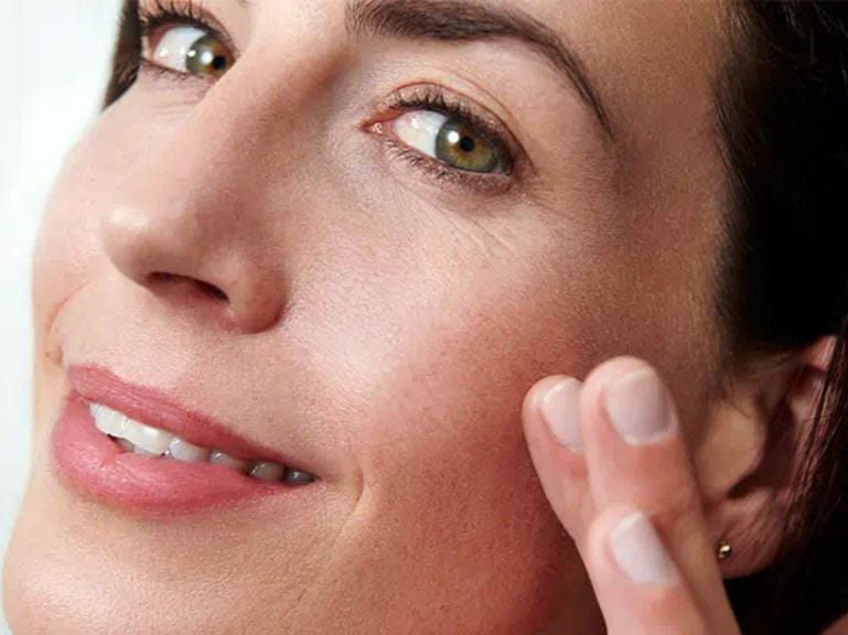 Women applies anti-aging cream
