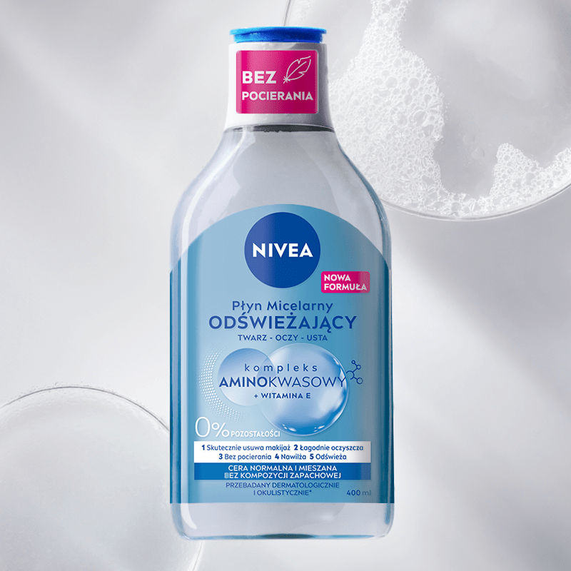 A bottle of NIVEA Micellar Water for Normal Skin lays on a blue bubble textured background.